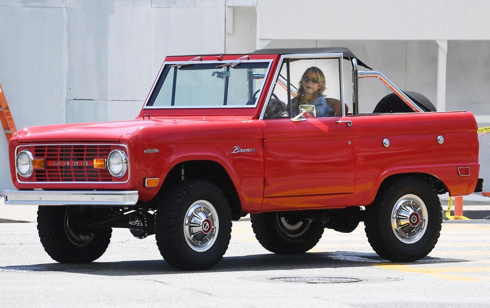 Sydney in her cherry red Ford Bronco, the car that kickstarted her TikTok page