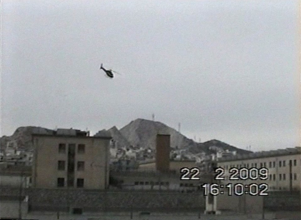 a helicopter is flying over a city on 22 2 2009