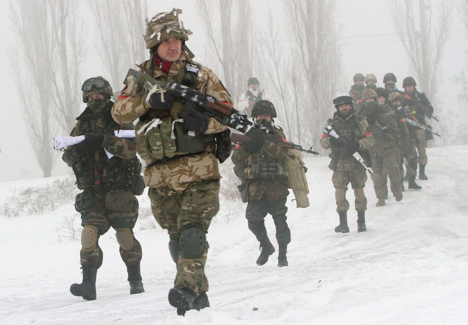 Ukrainian servicemen of the Donbass volunteer battalion take part in clean-up operations on their border with Russia