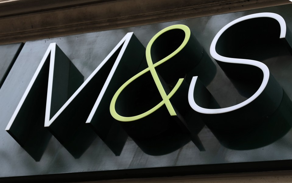 a m & s sign that is green and white