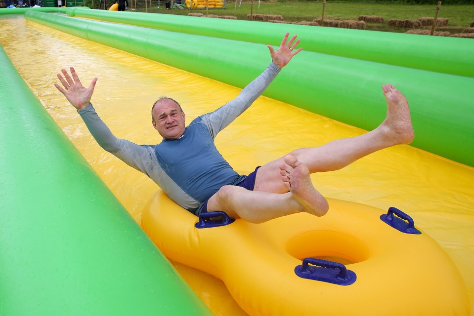 The Liberal Democrat's leader enjoys a ride on a waterslide