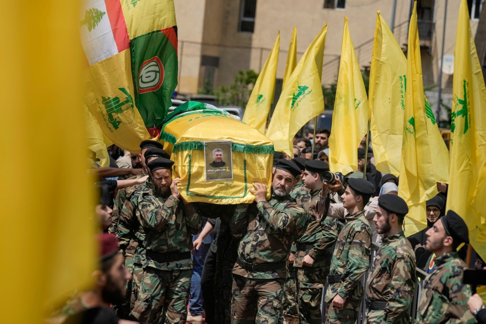 Hezbollah fighters carry the coffin of senior commander Taleb Sami Abdullah