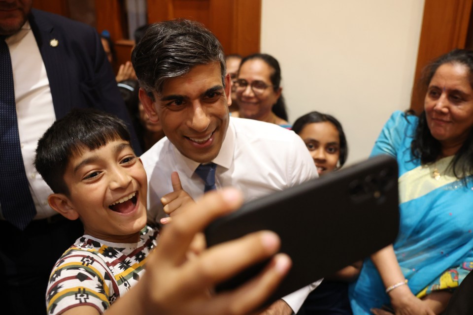 Rishi Sunak poses for selfie during a visit to the APS Swaminarayan Mandir, popularly known as Neasden Temple