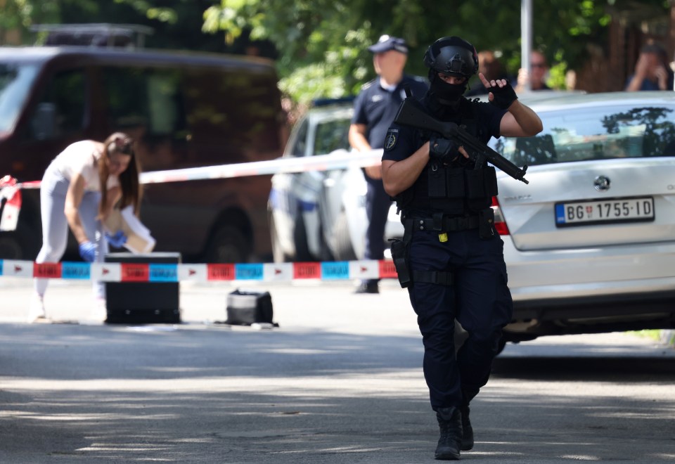 Armed cops stand guard outside the Israeli embassy after the attack