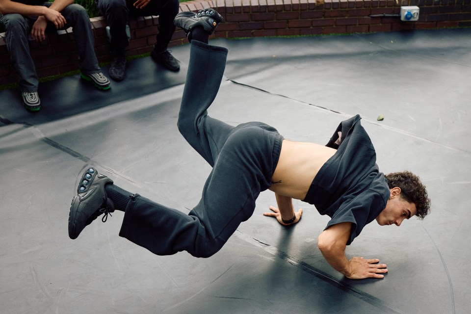 a man is doing a handstand on a black mat