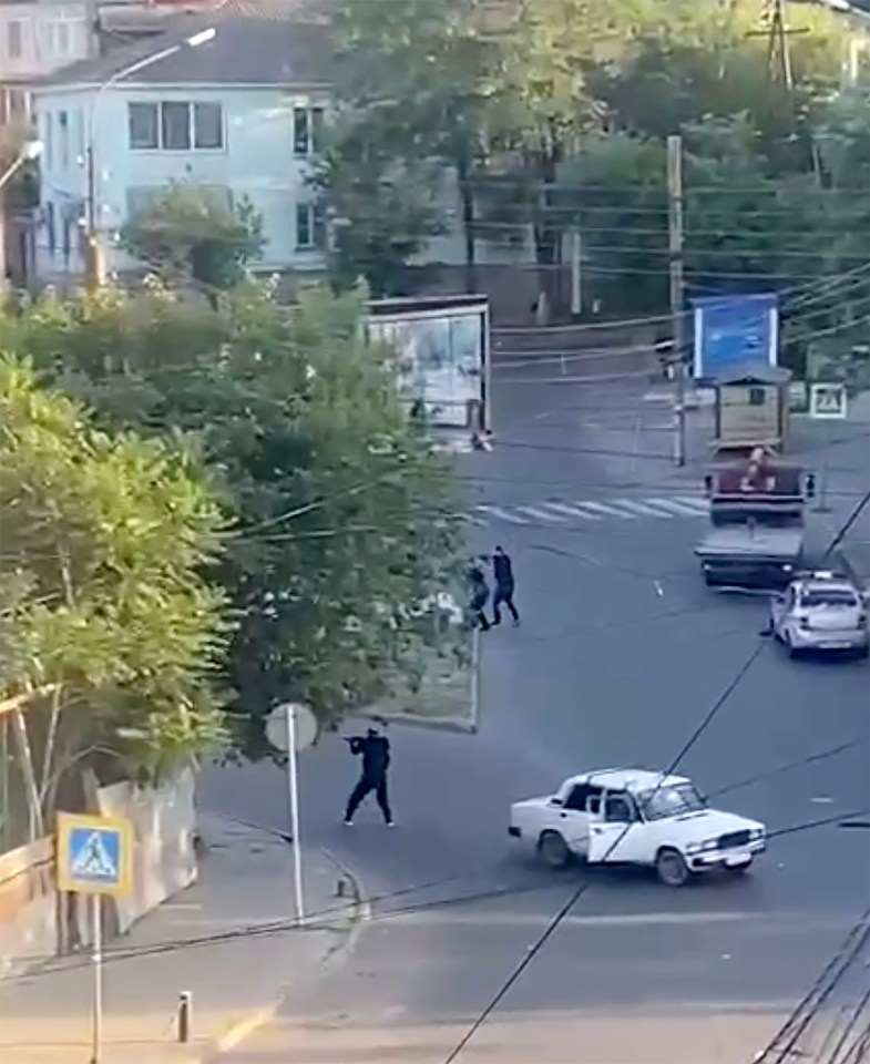 The three gunmen stand and take aim during the attack