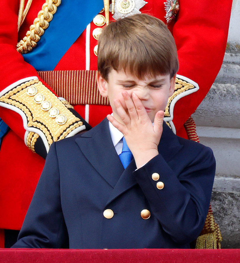 Sweet Louis was snapped wiping his nose while standing on the balcony