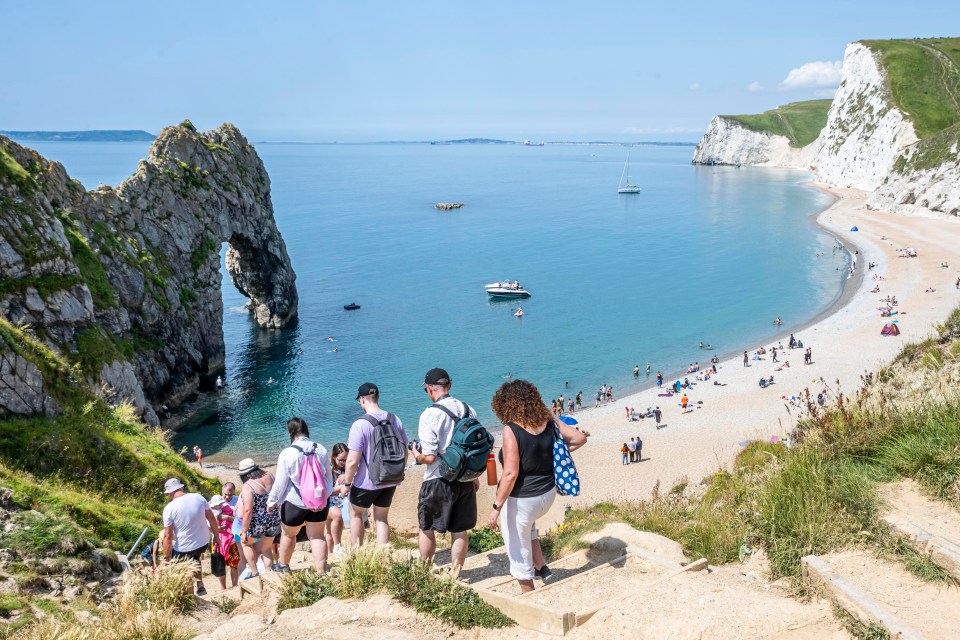 Walkers explored Durdle Door on the Jurassic Coast, Dorset, on Tuesday