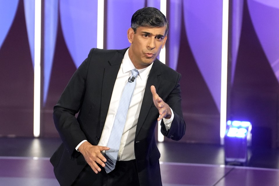 a man in a suit and tie stands in front of a purple background