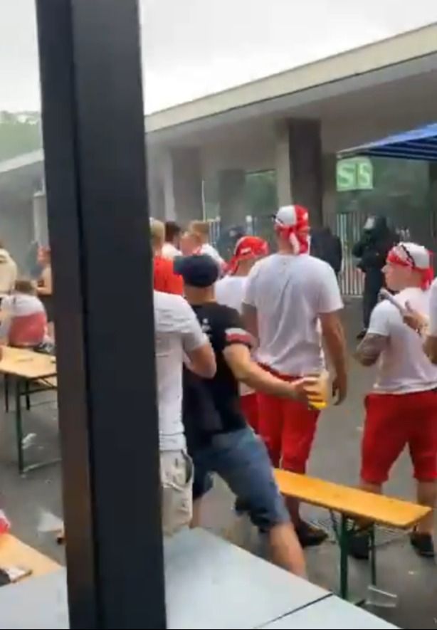 Video shows a fan preparing to launch a beer towards a number of riot police officers