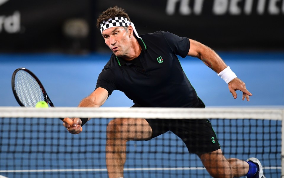 ADELAIDE, AUSTRALIA - JANUARY 07: Pat Cash of Team Cash in action in doubles match with partner Borna Coric against Henri Leconte of Team Leconte and Eugenie Bouchard of Team Cash during day one of the 2019 World Tennis Challenge at Memorial Drive on January 7, 2019 in Adelaide, Australia. (Photo by Mark Brake/Getty Images)