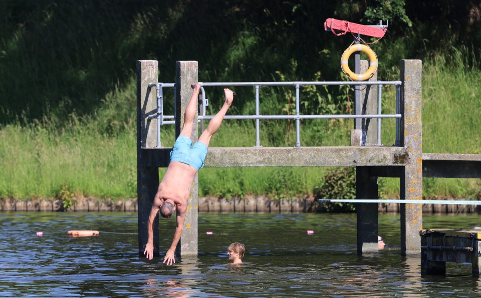 A man enjoys a dip at Hampstead Ponds in North London