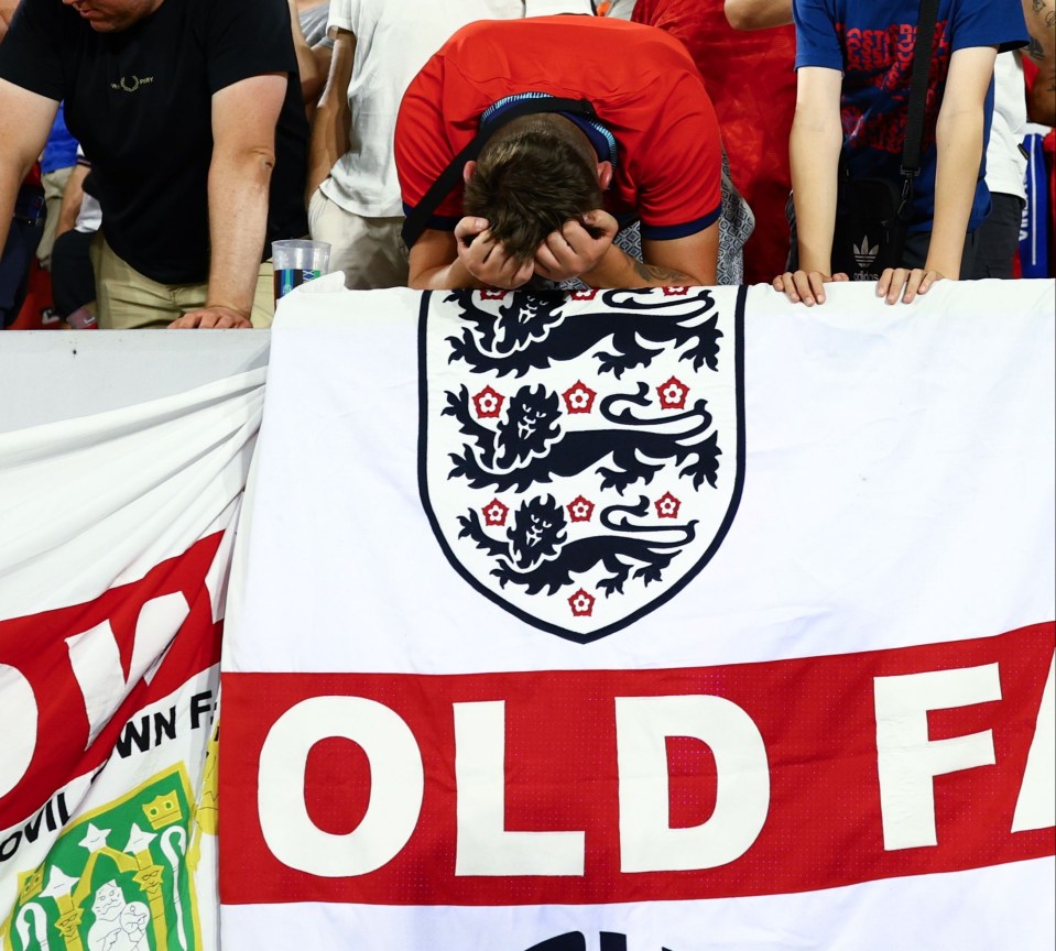 a man covering his face behind a flag that says old f