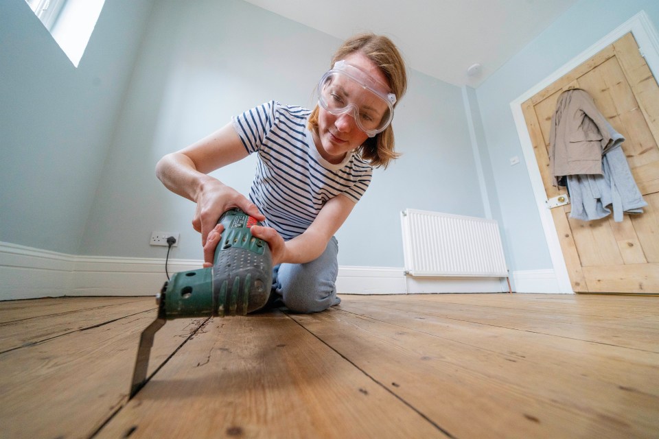 A volunteer suggested Rosie swap the handsaw that she had reserved for an electric multitool, which he explained would be better for cutting some wood out of an awkward corner