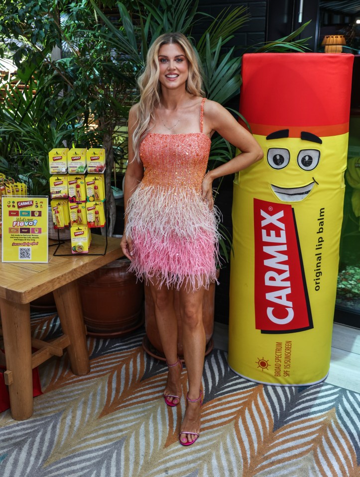 Ashley James dazzled in this sequin feather dress at the Carmex lip care event