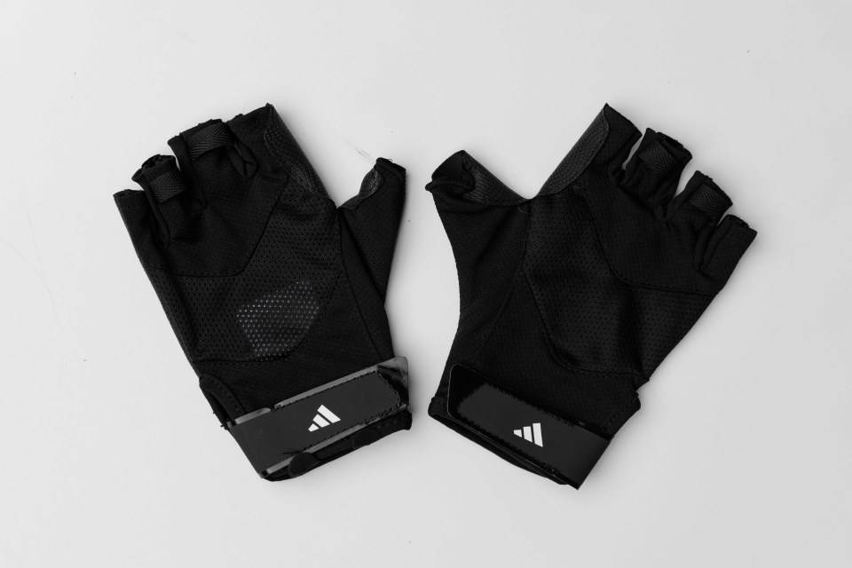 Pair of black Adidas fingerless gloves.