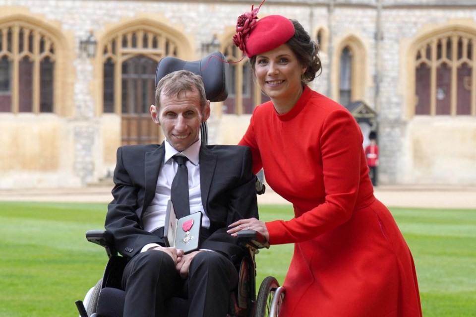 Burrow and his wife Lindsey pose for a photo after Rob is appointed an MBE