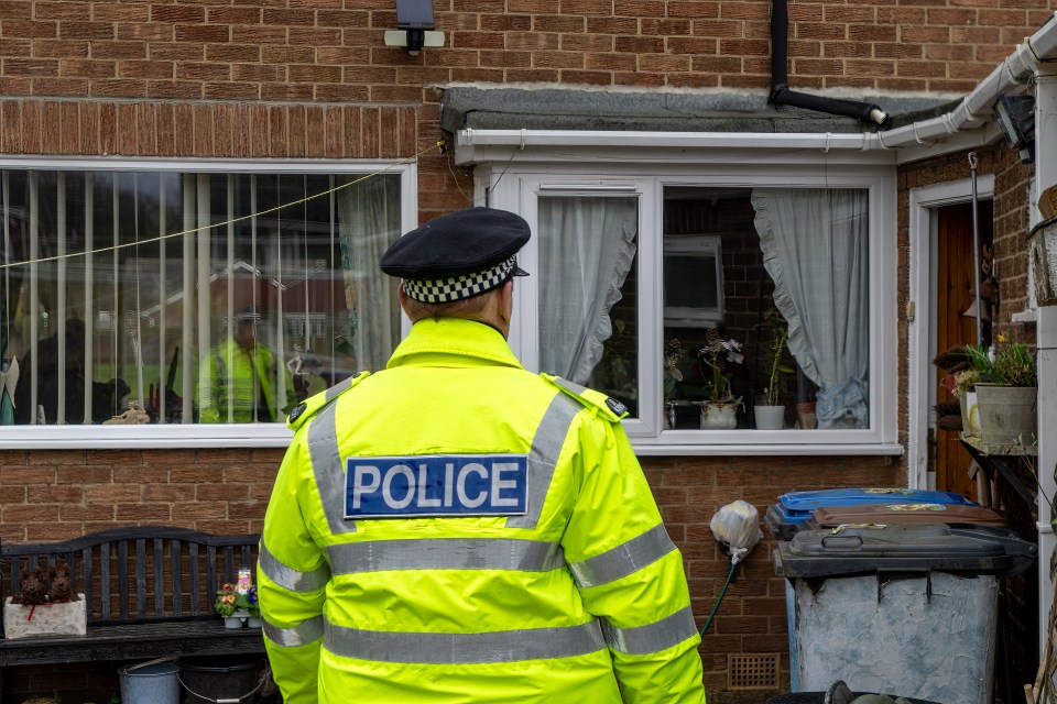 A policeman walking towards an elderly person's home.