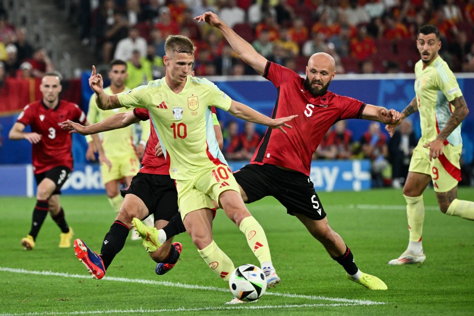 (From L) Spain's forward #10 Daniel Olmo and Albania's defender #05 Arlind Ajeti fight for the ball during the UEFA Euro 2024 Group B football match between Albania and Spain at the Duesseldorf Arena in Duesseldorf on June 24, 2024. (Photo by Alberto PIZZOLI / AFP) (Photo by ALBERTO PIZZOLI/AFP via Getty Images)