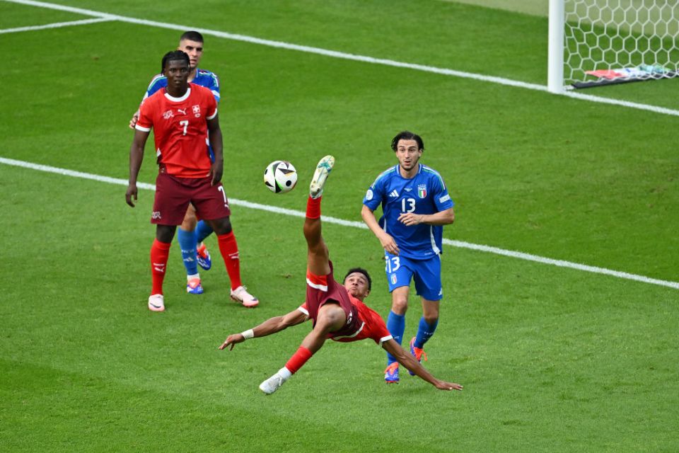 BERLIN, GERMANY - JUNE 29: Dan Ndoye of Switzerland attempts an overhead kick whilst under pressure from Matteo Darmian of Italy during the UEFA EURO 2024 round of 16 match between Switzerland and Italy at Olympiastadion on June 29, 2024 in Berlin, Germany. (Photo by Dan Mullan/Getty Images)