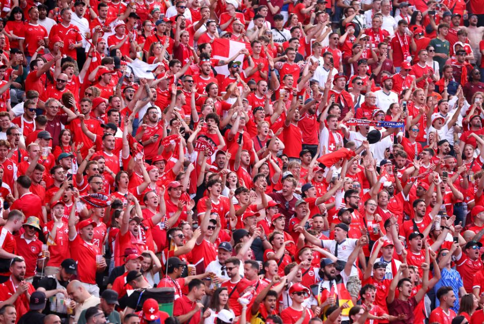 BERLIN, GERMANY - JUNE 29: Fans of Switzerland show their support during the UEFA EURO 2024 round of 16 match between Switzerland and Italy at Olympiastadion on June 29, 2024 in Berlin, Germany. (Photo by Alex Grimm/Getty Images)