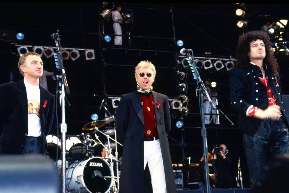 Queen members John Deacon, Roger Taylor and Brian May on stage at the Freddie Mercury tribute concert