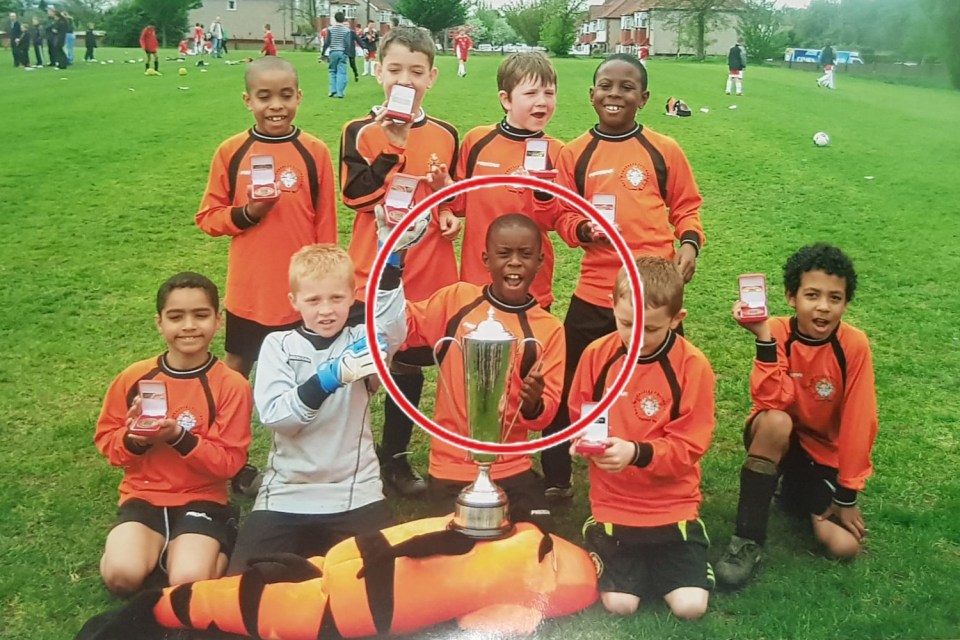 Marc (circled) aged around seven, celebrates a trophy with South London club Cray Wanderers