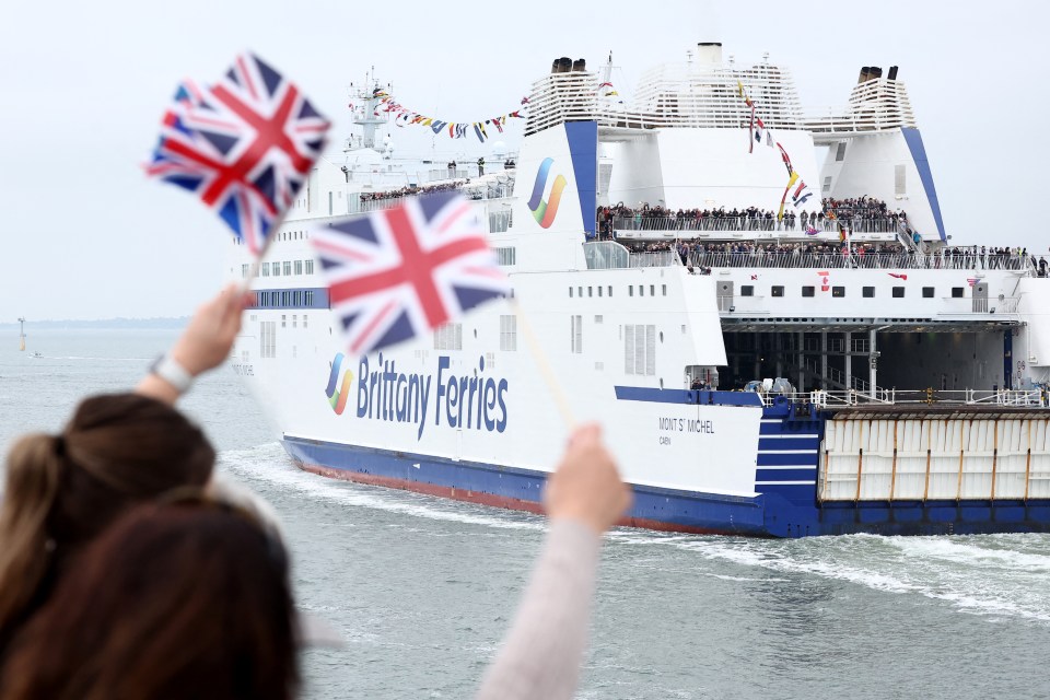 Well-wishers waved Union Jack flags as D-Day veterans travelled from England to Caen