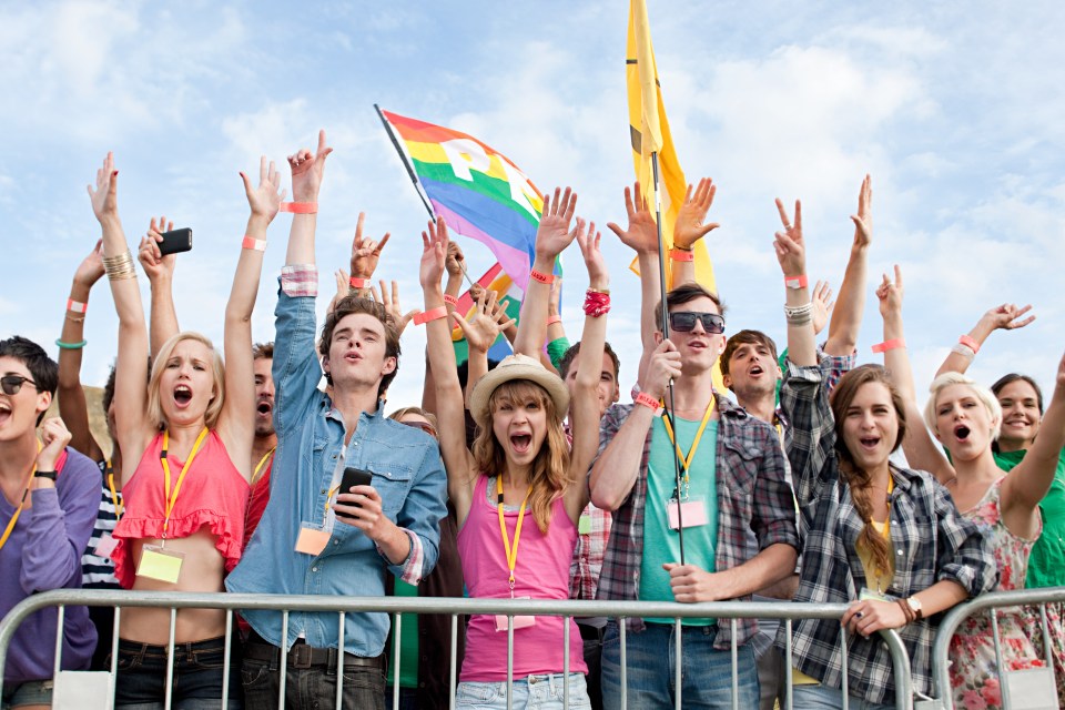 Young people cheering at a festival