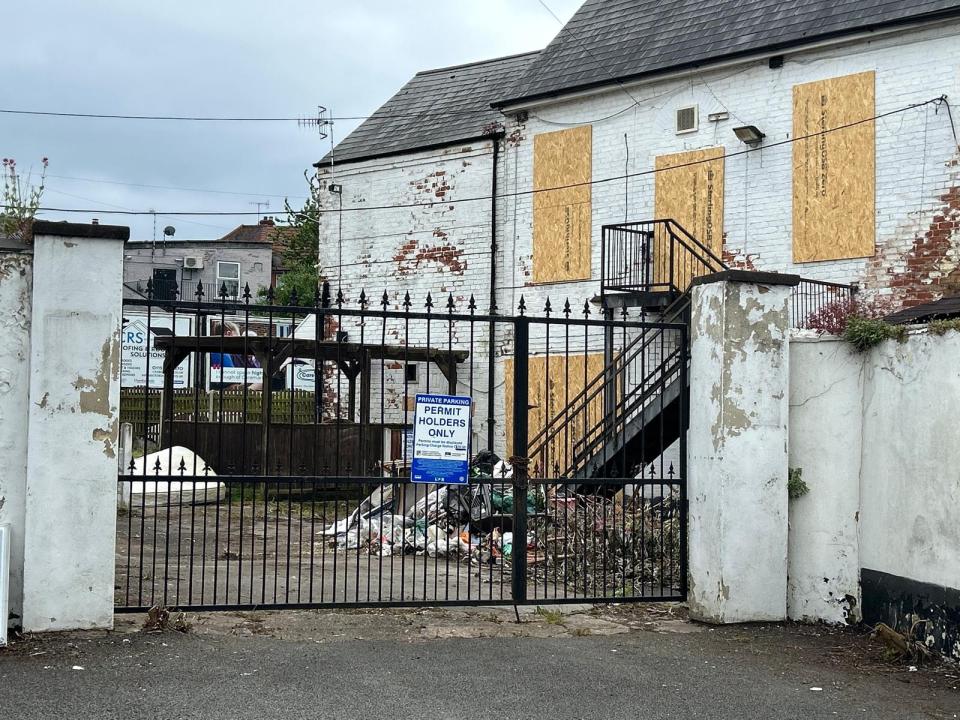 A pile of rubbish can be seen just inside the premises