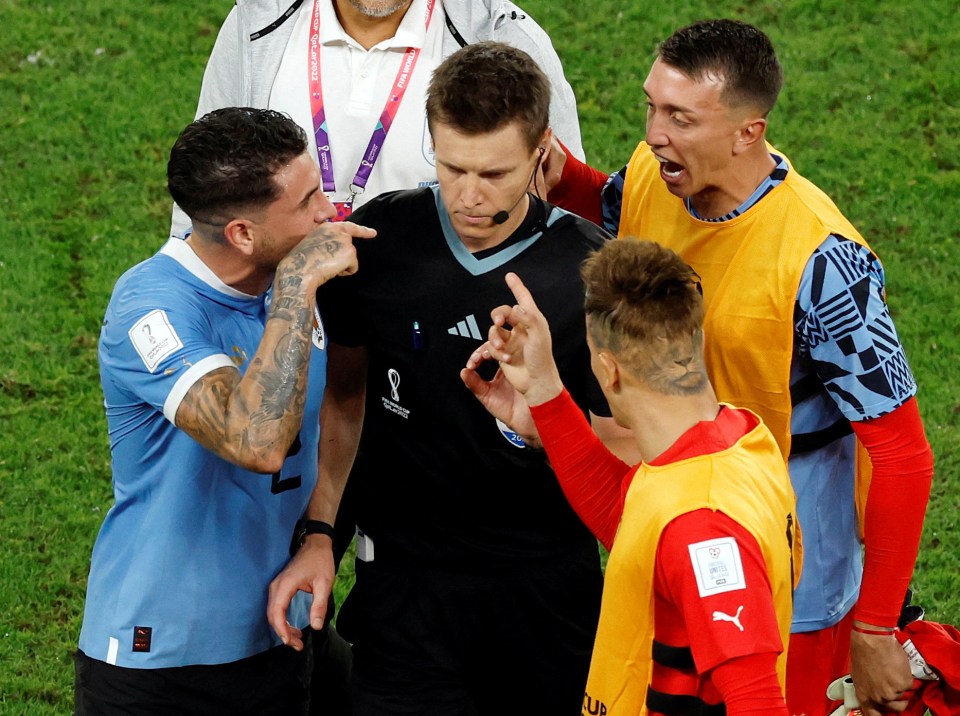 Soccer Football - FIFA World Cup Qatar 2022 - Group H - Ghana v Uruguay - Al Janoub Stadium, Al Wakrah, Qatar - December 2, 2022 Uruguay players remonstrate with the referee Daniel Siebert after the match REUTERS/Albert Gea TPX IMAGES OF THE DAY