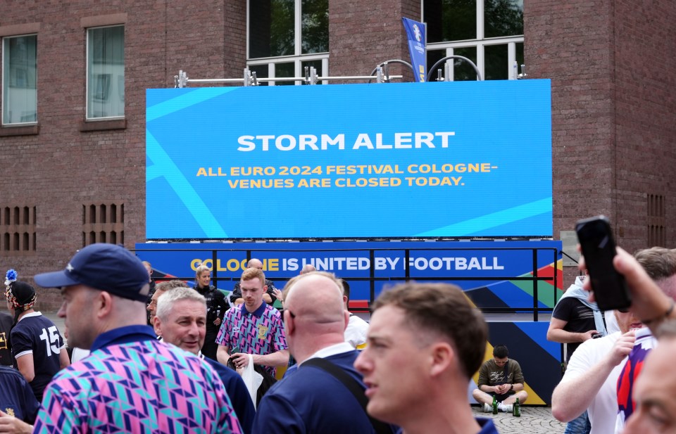 A giant screen displays a message to fans highlighting a storm alert for Cologne, where Scotland will face Switzerland on Wednesday.