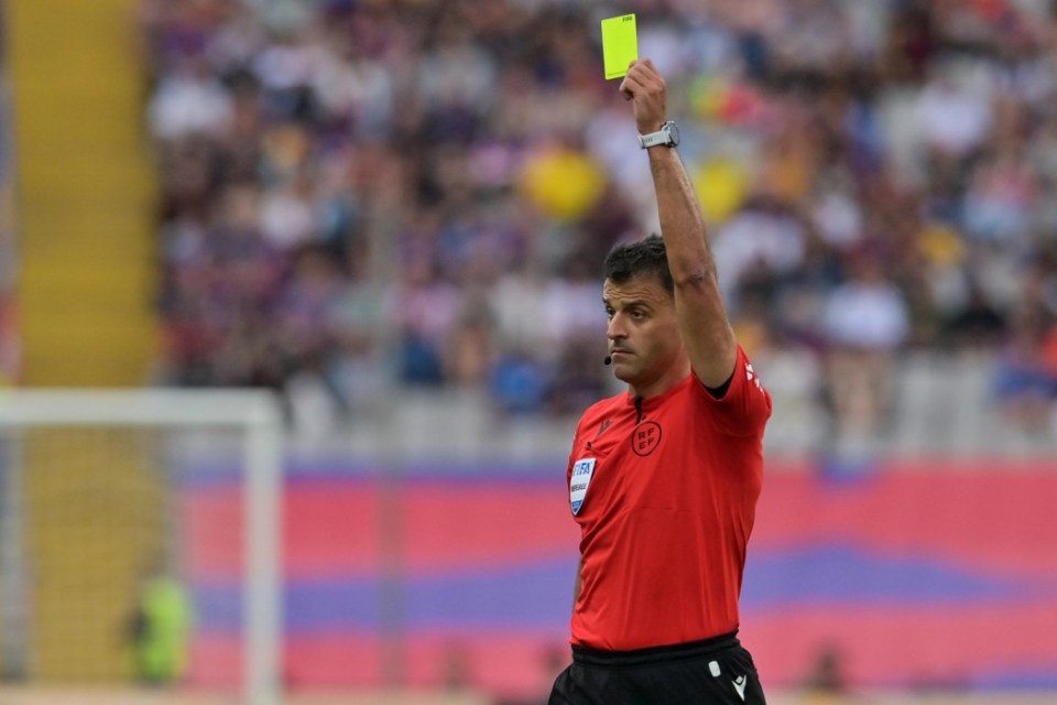 Spanish referee Jesus Gil Manzano shows a yellow card during the Spanish League football match between FC Barcelona and Rayo Vallecano de Madrid at the Estadi Olimpic Lluis Companys in Barcelona on May 19, 2024. (Photo by MANAURE QUINTERO / AFP) (Photo by MANAURE QUINTERO/AFP via Getty Images)