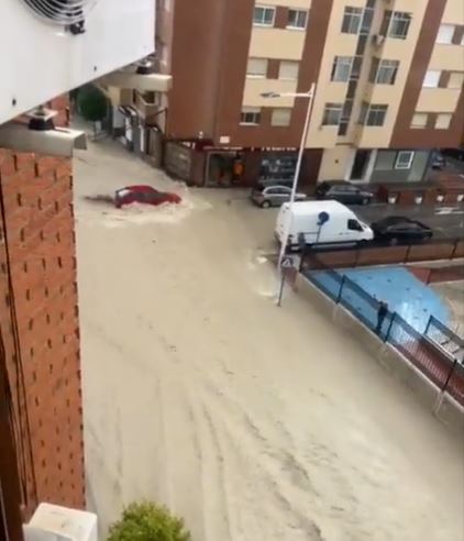 A red car is swept away in heavy storms in Murcia