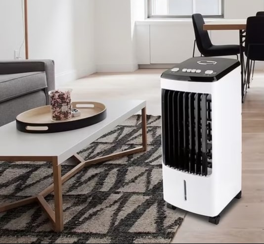 a white air cooler is sitting in the middle of a living room