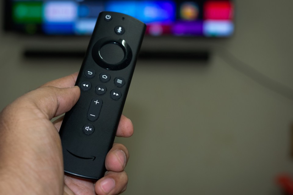 Amazon fire stick TV remote in hand