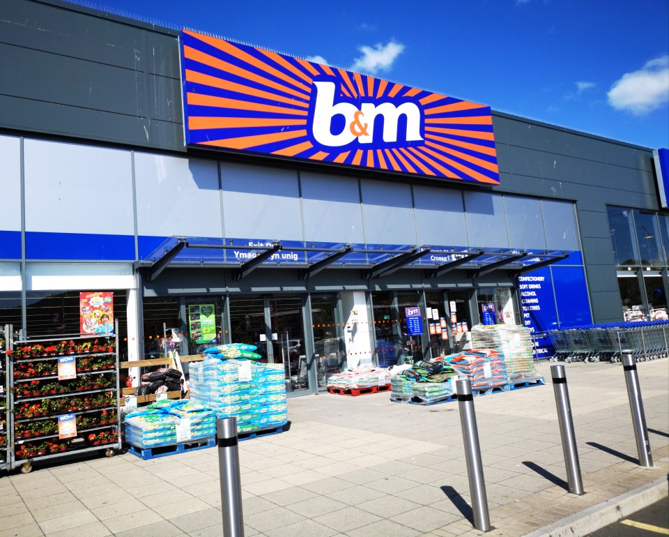 the outside of a b & m store with a blue sign