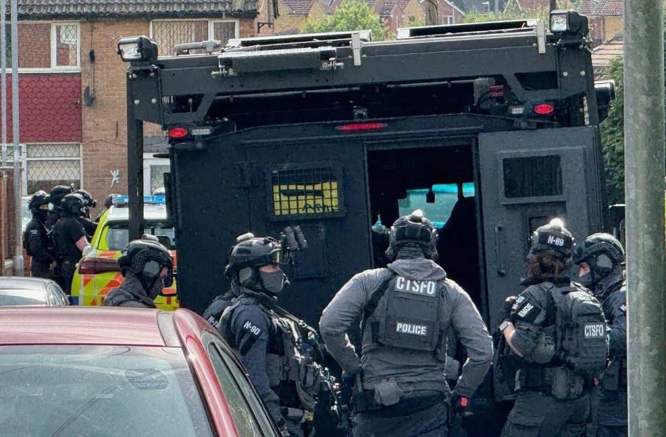 Armed cops at the scene in Leeds yesterday