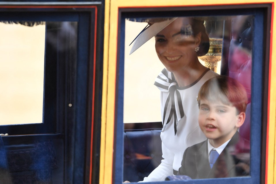 Louis smiled as he sat next to mum Kate in the carriage