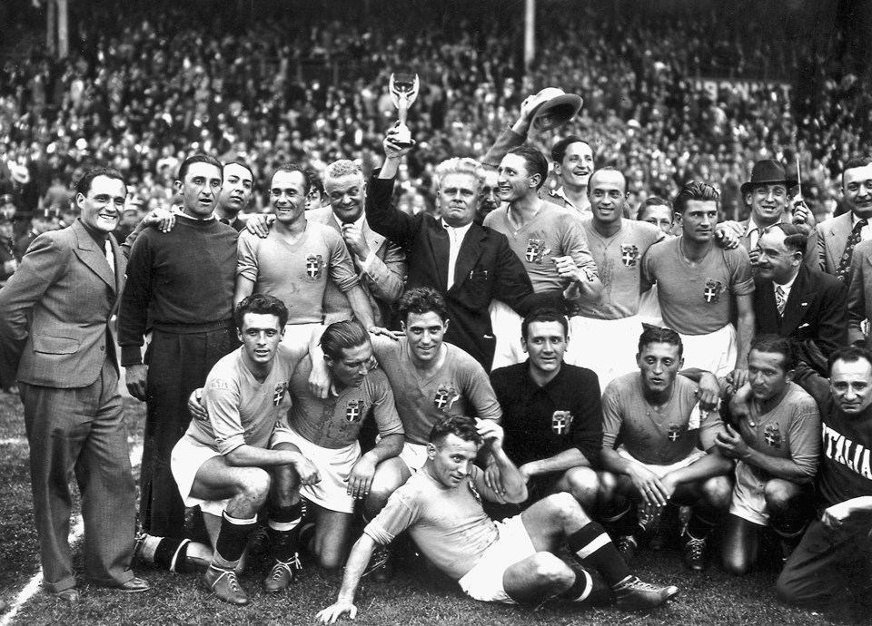 a black and white photo of a soccer team holding a trophy