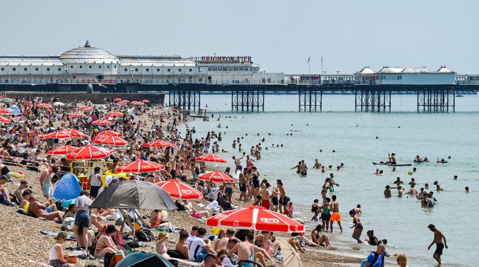 Crowds enjoy the hot sunshine on Brighton beach on Tuesday