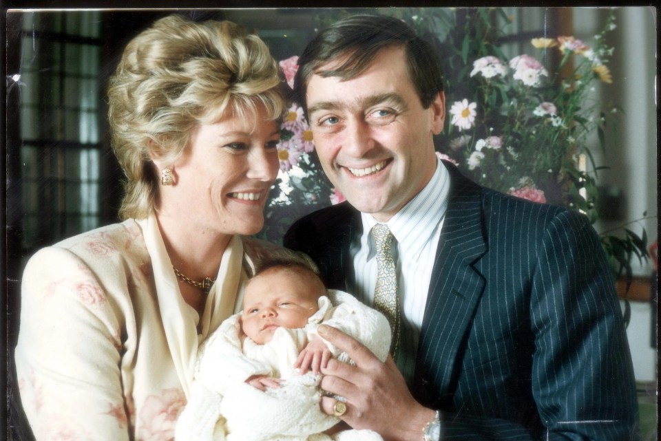 Hugh as a baby with his late father and his mother