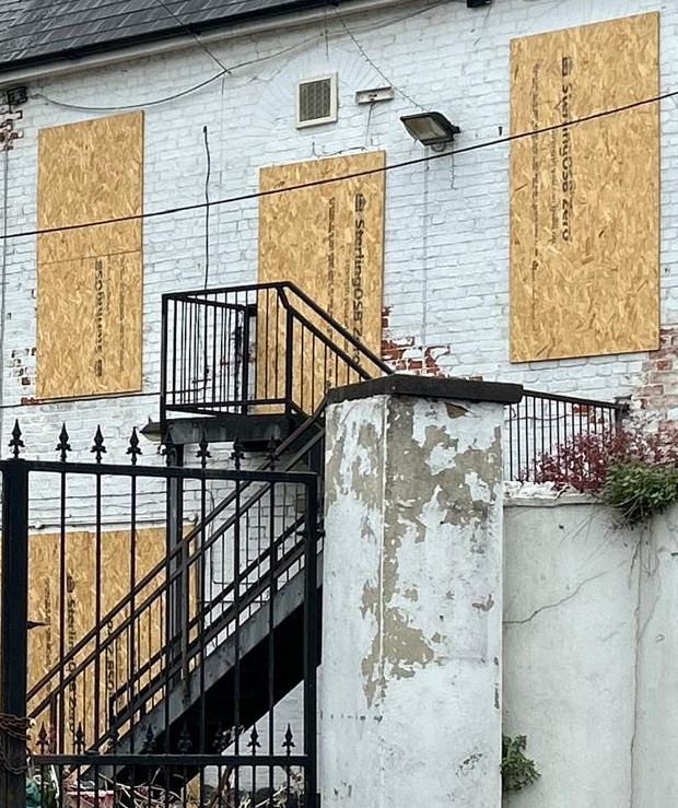 The boarded-up windows came after people came in and smashed them, Malcolm said