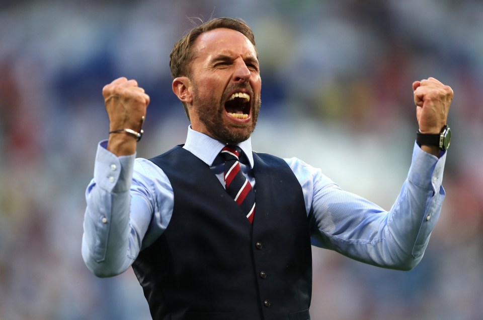 a man in a suit and tie with his arms in the air