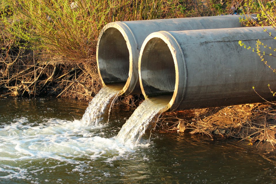 two concrete pipes with water coming out of them