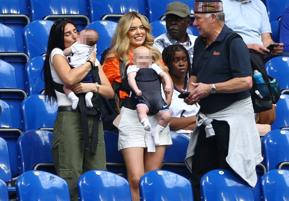 Annie and Georgina Irwin, wife of Aaron Ramsdale, laugh with their kids in the stands