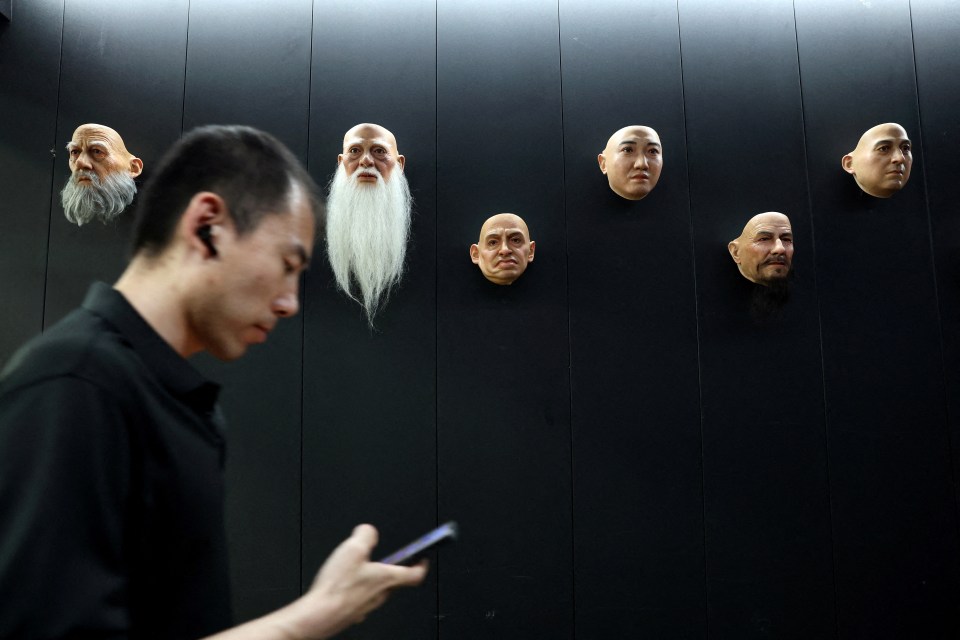 Disembodied silicone heads sit along the walls of China’s haunting humanoid robot factory