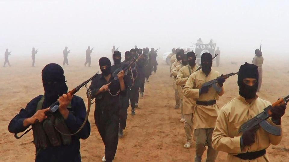 ISIS fighters march in propaganda photos released by the terror group