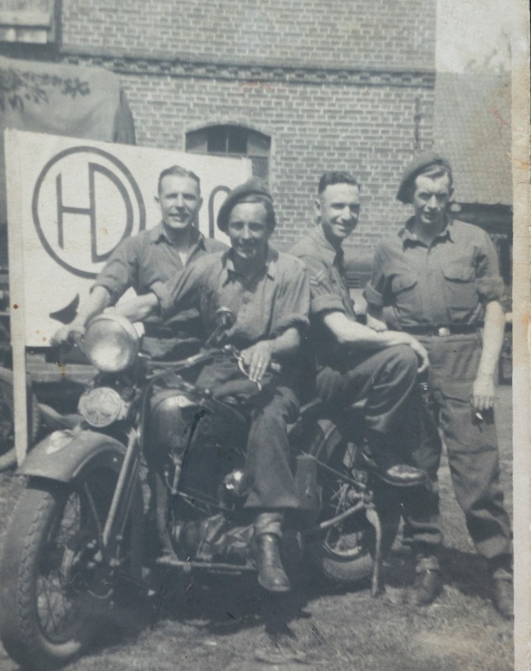 Don, front, sits on a captured German motorbike after the war ends