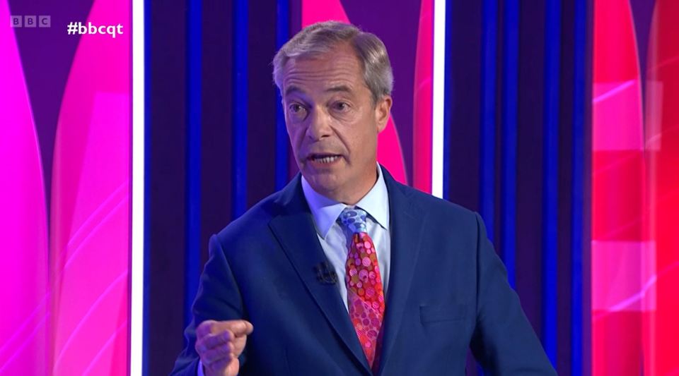 a man in a suit and tie stands in front of a bbc logo